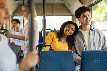 Happy smiling guy and lady taking bus together © Prostock-studio