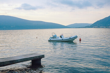 Blue Mediterranean landscape with boat on water. Montenegro,  Kotor Bay. Color tinting