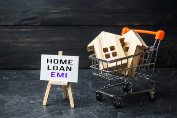 Houses in shopping cart and easel with home loan EMI. Equated Monthly Installment loan. Reducing...