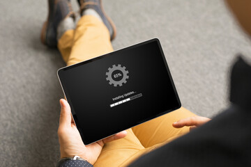 Man installing software updates on tablet computer