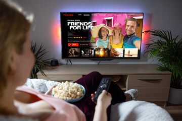 Woman watching TV series and movies on online streaming service at home - obrazy, fototapety, plakaty
