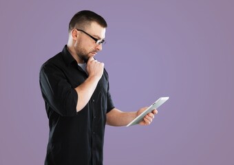 Young cool student in casual clothes use work on tablet pc computers