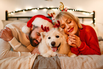 Couple in love for New Year and Christmas with a dog at home