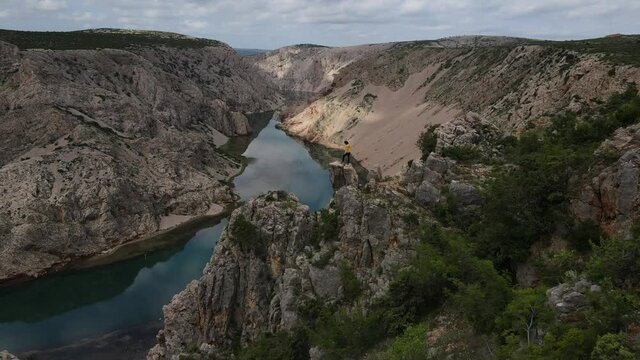Zrmanja Canyon in Croatia. Woman stands on the precipice of a canyon