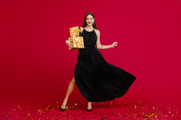 attractive woman celebrating Christmas on red background
