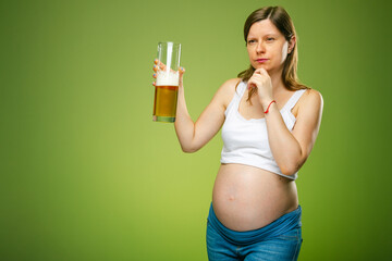 Pregnant woman with thinking face expression and bear in a big glass, to drink alcohol or not when...