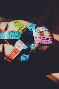 abstract art portrait of young man with measuring tapes through mouth on body dysmorphia, self image, height *2