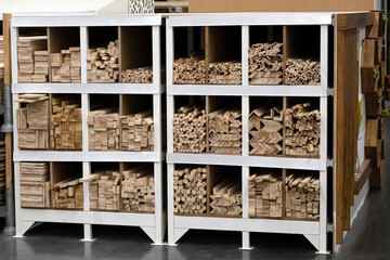 A rack with bars of wood. Put new wooden sticks on the shelves in the sawmill of a large hardware...