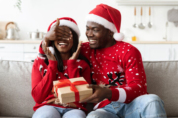 Loving black man greeting his girlfriend, celebrating New Year