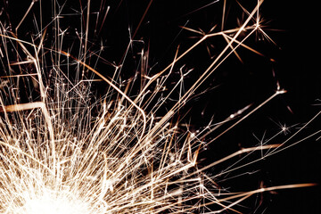 New years eve sparkler isolated on black. Shiny blow of firework sparks. Pyrotechnics background. Fire texture.