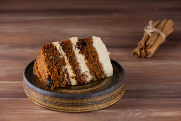 Piece of vegan carrot cake with cinnamon and walnuts on a plate. Sugar, gluten, lactose free,...