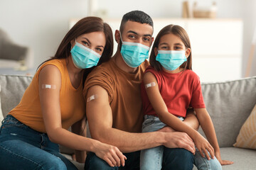 Arab Family In Masks Showing Adhesive Bandage After Receiving Injection