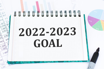 2022 -2023 goal text on a notebook with divgrams and numbers on the table