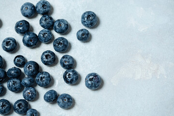juicy, freshly picked, ripe and wet blueberries on an old cracked background