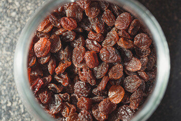 Close-up of raisins in a glass jar top view