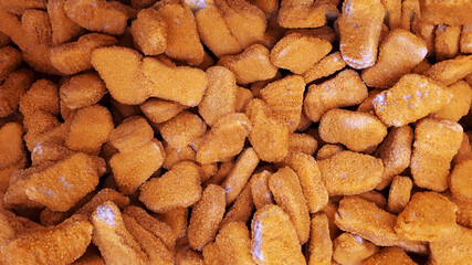 Stack Raw Frozen Chicken Nuggets. Several Chicken Nuggets In Breading Close-Up