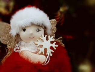 Close-Up Of A Fabric Christmas Angel With A Magic Wand In The Shape Of A Snowflake