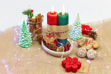 New Year's, Christmas table decor with red-green candles, pine cones, spruce branches, garlands on a white background.