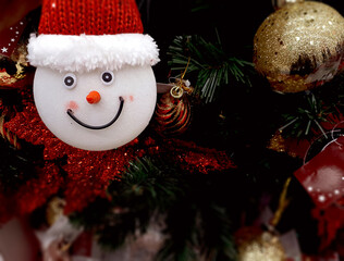Felt Snowman Head Ornament With Blurred Christmas Tree Background