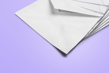 White envelopes on the background, made of paper, used to enclose letters or document.