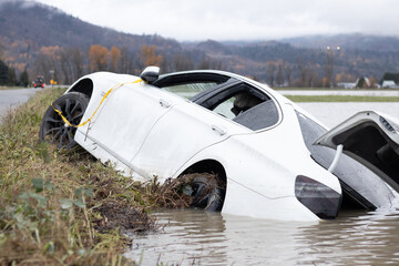 Abandoned car slid off road in Abbotsford flooding and storm, British Columbia, Canada