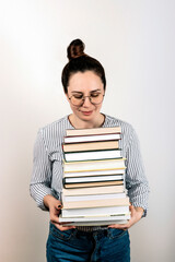 Woman with stack of books on plain background