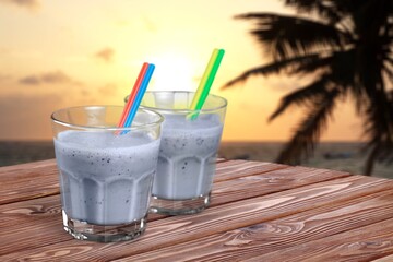 Cocktail drinks with blur tropical beach and sunset in the background