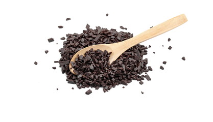 Chocolate sprinkles in a wooden spoon isolated on white background. Grated chocolate isolated on white background.