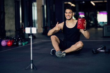 Fototapeta na wymiar Young Arab Fitness Blogger Advertising New Fitness Nutrition In Social Media