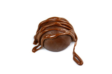 Chocolate truffle ball covered with melted chocolate isolated on white background.