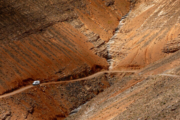 Images of Morocco. A 4x4 van on the dirt road down to the Dades Valley in the Atlas Mountains