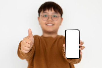 Cheerful chubby asian boy using smartphone with empty screen, mockup