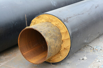 A close-up of pre-insulated multilayer metal steel pipe for hot water and heating. Prefabricated...