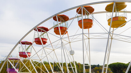 Aerial view of a ferris wheel inside Rome amusement park, located in the Eur district. There is no one on the rides.