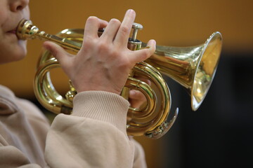 Child playing trumpet musical instrument close up - obrazy, fototapety, plakaty