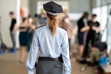 female police officer in uniform on duty during a public event