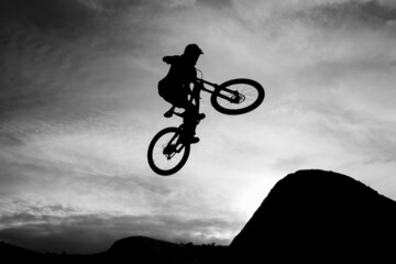 Downhill Mountain Biker at the Kamloops Bike Ranch jumping one of the 6-pack jumps.