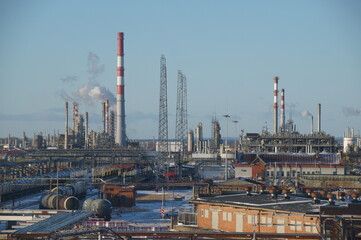 An oil and gas processing plant. Factory buildings, production pipes, railway tanks. Panorama of a large factory.	
