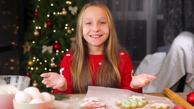 Teenage girl baking christmas gingerbread cookies at home