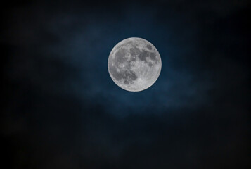 Naklejka na ściany i meble Full moon against the black cloudy night sky