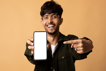 Smartphone with blank screen in young hindu man hand