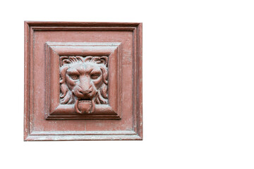 panel of an old wooden door with a bas-relief of a formidable lion's head isolated on white background