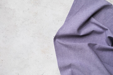 Textile purple napkin on the right side of the table with copy space, food background