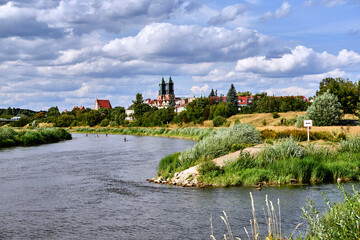 The towers of the gothic cathedral on the Warta river - obrazy, fototapety, plakaty