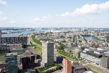 Fototapeta premium Aerial view of the Rotterdam skyline with in the background a lot of industry in the Netherlands