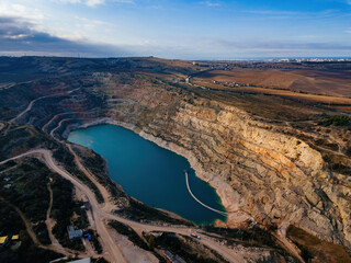 Abandoned limestone quarry with lake at the bottom
