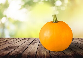 Thanksgiving Day pumpkin on a wooden desk