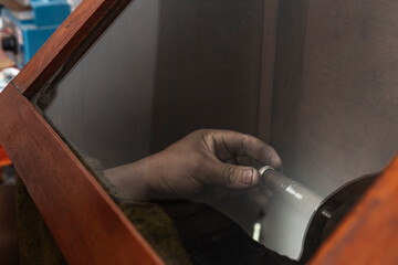 Close up view of a jeweller polishing the inside ring with an electric lathe