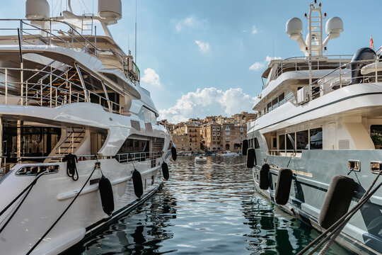 Luxury Motor Boats In Vittoriosa Yacht Marina,Malta.Sunny Summer Day.Holiday High Class Lifestyle Travel Concept.Boat Trip In Mediterranean.View Of Expensive Sailing Yachts At Pier.Posh Vacation