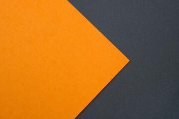 Abstract background from sheets of orange, and black paper. Orange cardboard on a background of black cardboard top view. Thick paper of different colors top. Abstract paper - creative design.